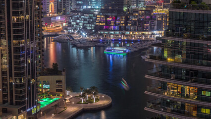 Aerial view of Dubai Marina residential and office skyscrapers with waterfront day to night...