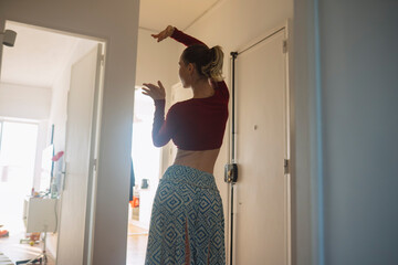 Woman performing with flowing movements in warm indoor light