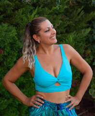 portrait of a beautiful young woman smiling at camera in the garden