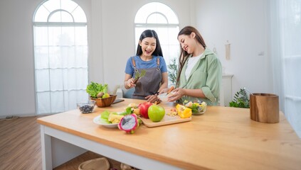 Friends cooking together in modern kitchen, preparing healthy meals with fresh ingredients during daytime