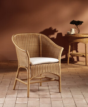 Still life of a wicker chair on a stone floor