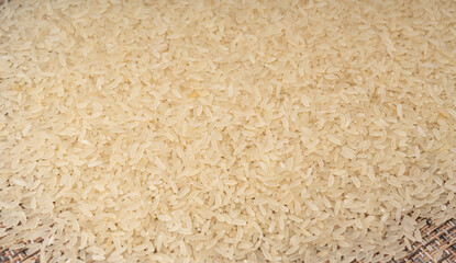 White parboiled rice grains. Dry uncooked ponni rice, small organic basmati