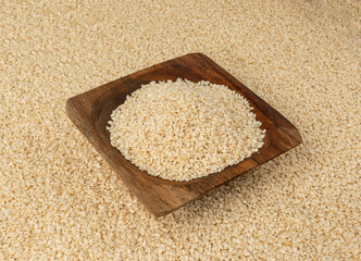 Sesame seeds pile closeup, white small benne grains. Sesamum indicum fruits
