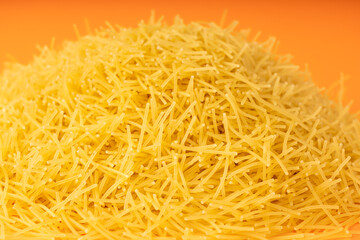 Raw vermicelli textured background, gold soup pasta pattern, small homemade noodles mock up