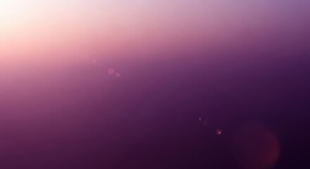 Abstract purple and pink gradient background with subtle lens flare and bokeh effect, soft light transition