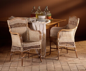 Still life of wicker chairs on a stone floor