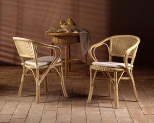 Still life of wicker chairs on a stone floor