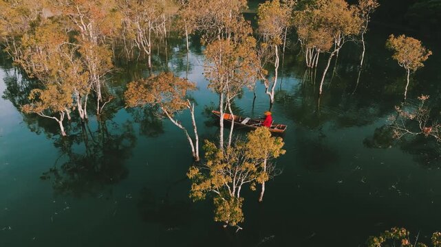 4K Aerial View Of local Person Rowing Wooden Boat in Tuyen Lam Lake Mist, Dalat, Vietnam Travel
the iconic submerged trees of the Suoi Tia ecological area and layers of distant mountains obscured by f