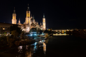 Obraz premium Christmas Lights Illuminating the Cathedral-Basilica of Our Lady of the Pillar and Puente de Piedra Bridge over the Ebro River at Night, Zaragoza, Spain