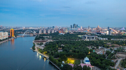 Fototapeta premium Elevated view over the city center with river and park and central business district day to night Timelapse, Kazakhstan, Astana