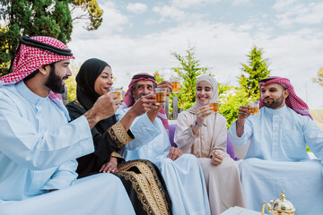 Middle eastern muslim family enjoying tea and togetherness outdoors