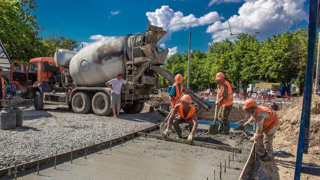 Concrete leveling works for road construction with many workers and mixer timelapse