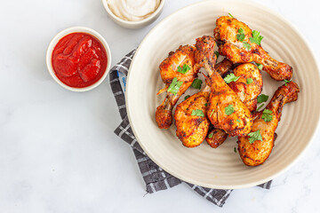 Healthy Oven-Baked Chicken Drumsticks Top Down Photo with Condiments