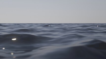 A serene ocean scene with gentle waves and a soft light.