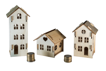 Three small wooden house models with stacks of coins placed on a transparent background, depicting concepts like property investment, mortgage loans, home ownership, and savings for future housing