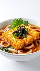 Delicious Japanese Udon Noodle Soup with Fried Tofu and Squid Rings.