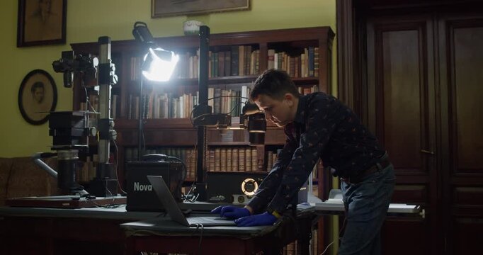 Museum or library staff digitally archives historical materials using a professional camera and custom setup. Highlights digitization workflow, archival standards and cultural heritage preservation.