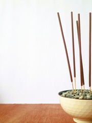 Burning incense sticks used for prayer and rituals to welcome the Lunar Chinese New Year, on white background with copy space