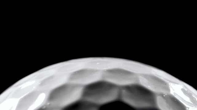 Closeup of rotating golf ball