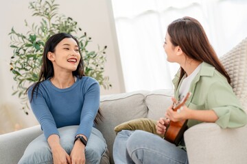 Two friends enjoy a music session together in a cozy living room during the afternoon