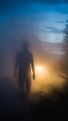 Fototapeta premium Silhouette of a person standing in thick fog illuminated by bright lights.