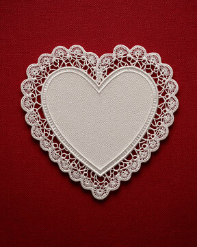 white lace heart on red background, lace heart decoration, romantic white heart doily
