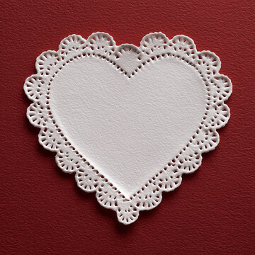 white lace heart on red background, lace heart decoration, romantic white heart doily
