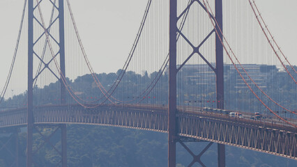 Running Lisbon half marathon crossing the 25 of April bridge over the Tagus river aerial view from above.