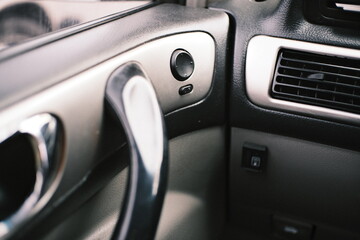 Set of close-up shots of a car interior featuring climate control buttons, dashboard switches, air...