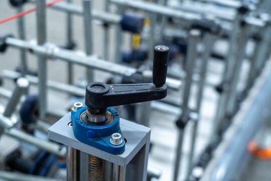  Hand crank adjustment handle on industrial machine frame