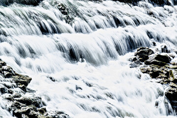 Water cascading over the rocks with a silky effect