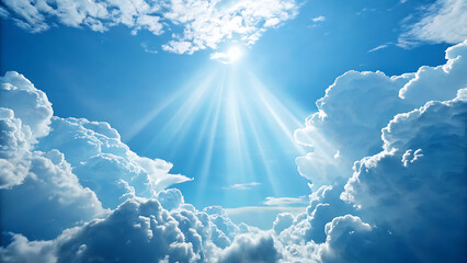 Bright sun rays shining through dramatic white clouds in a vibrant blue sky, representing hope, heaven, or divine light