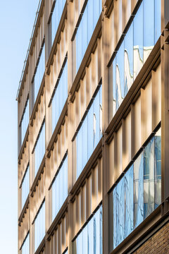 Modern abstract building facade displaying geometric pattern forms with symmetry, reflection and minimalism emphasizing architectural precision and clarity