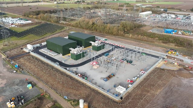 Aerial view of the imposing structures and electrical equipment contrasting against the surrounding landscape, Sutton Bridge, United Kingdom.