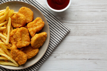 Chicken Nuggets with French Fries on a Plate, top view. Copy space.