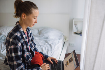 Focused mother manages studies during child care routines
