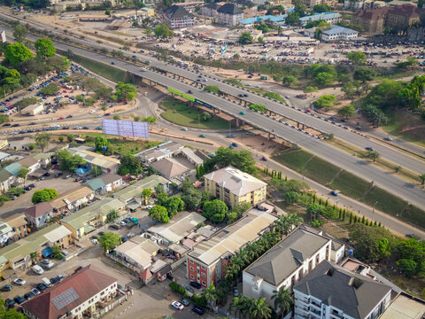 Aerial view of Area 1 Bridge, where the roads cut through the landscape like shimmering ribbons, reflecting the sun's golden light, Abuja, Federal Capital Territory, Nigeria.