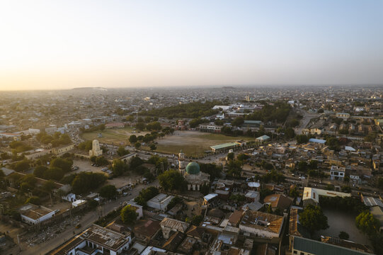 Aerial view of the Emir Palace Road area, with its buildings casting long shadows under the warm light, Kano, Kano, Nigeria.