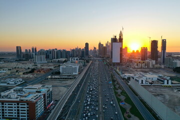 Aerial night view of Dubai skyline. Illuminated Sheikh Zayed Road highway traffic and modern skyscrapers in United Arab Emirates city center.