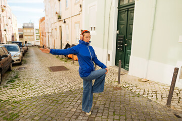 Dynamic performer on city street showcasing expressive dance movements