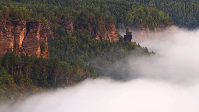 time-lapse video - autumn flowing inversion fog in the rocky valley
