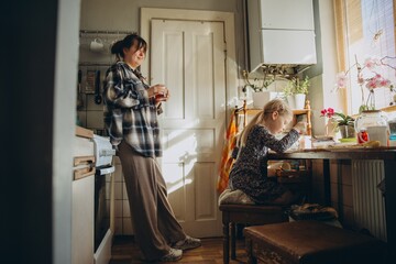 Fototapeta premium Mother and daughter enjoying quiet morning at home