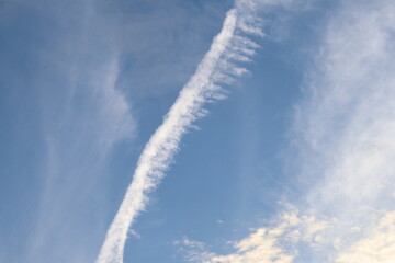 Sky's Breath: An ethereal display of vapor trails weaving across the vast canvas of a radiant sky, evoking a sense of wonder and boundless freedom. 