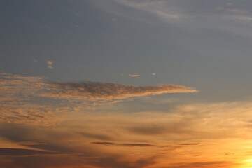 Sky Serenity: Witness the sky canvas painting itself with the fiery hues of dusk, where the sunlight caresses wispy clouds, bringing a sense of serenity.
