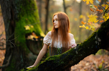 Red-haired woman in a medieval green cloak and corset posing in a mystical mossy forest, evoking an elven fairy-tale atmosphere with ethereal light and magical fantasy vibes.

