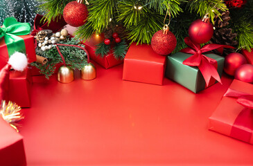 Festive red background with Christmas ornaments and gift boxes, holiday design for Christmas and New Year