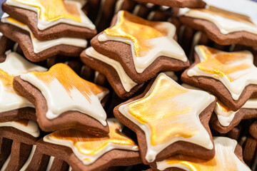 Golden Star-Shaped Christmas Cookies with White Royal Icing