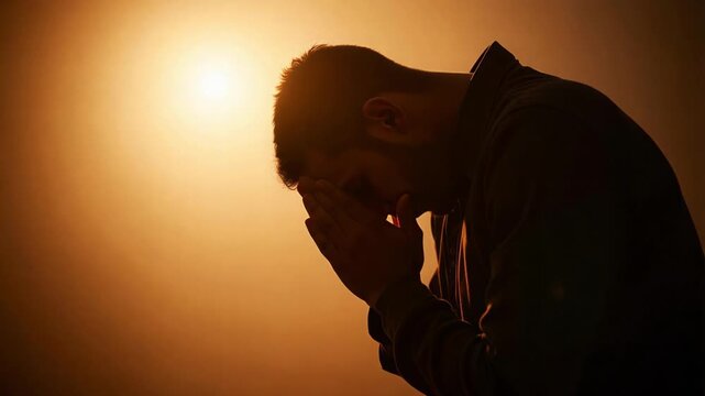 Silhouette of Faithful Religious Man Bowing Deeply in Earnest Prayer and Worship Showing Devotion and Spiritual Connection to God 4K