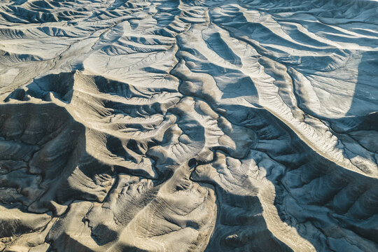 Aerial view of the sinuous canyons and textured badlands, etched by time and weather, paint a starkly beautiful scene, Moon Overlook Road, Utah, United States.