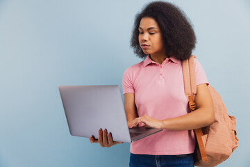 African American student holding laptop studying e learning